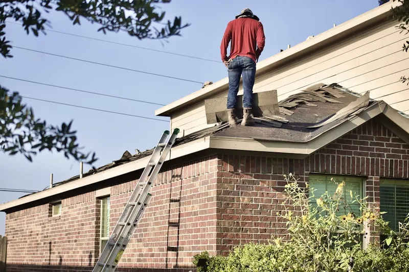 Professional roofer working on a residential roof in Bridgton